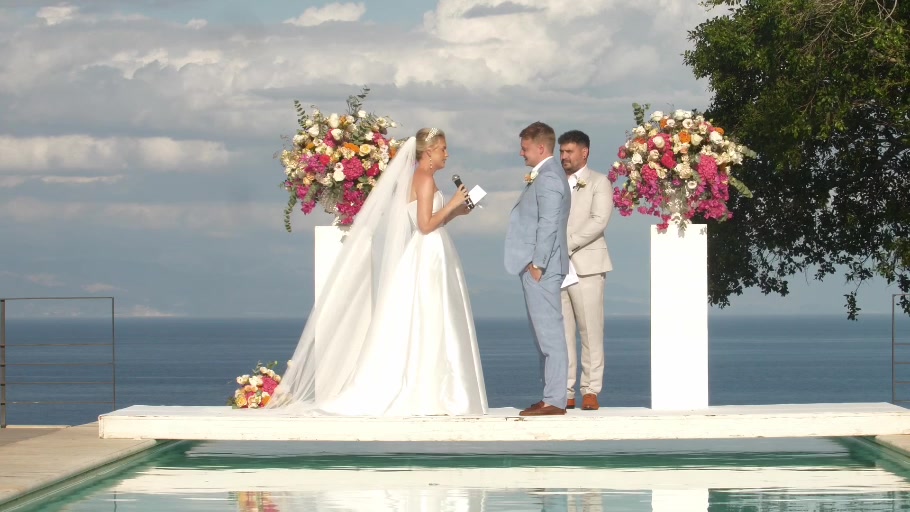 A couple exchanging vows overlooking the sea